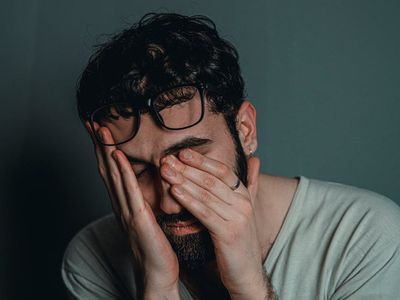 Detail of a person taking a deep breath outdoors